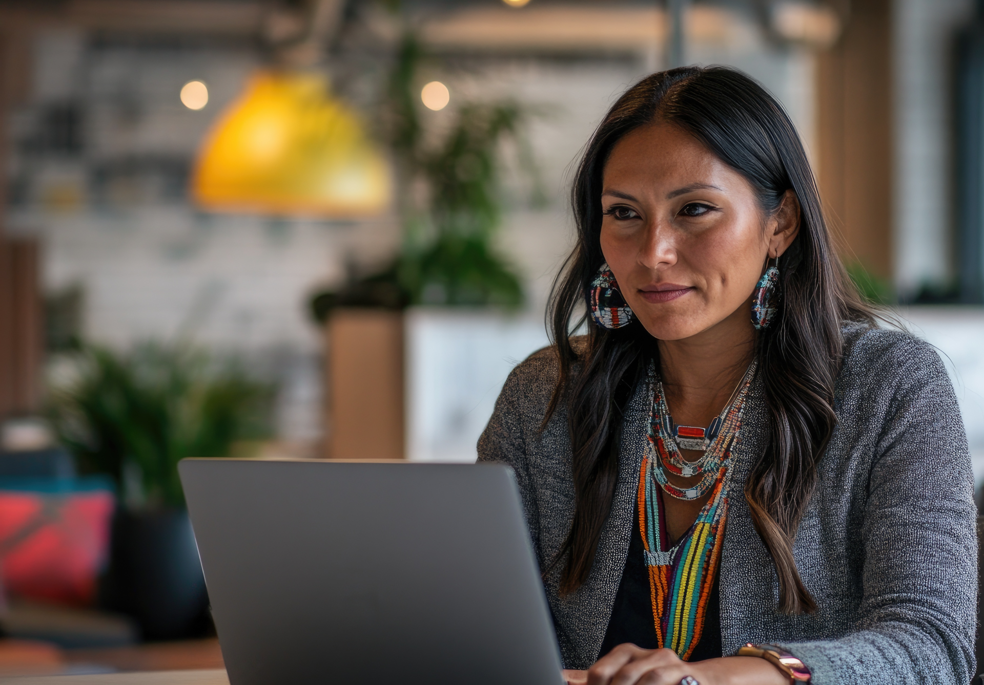 A smiling call center agent with headphones works in a modern office.