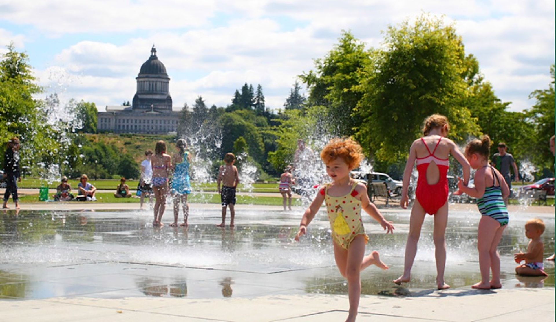 The Idaho State Capitol Building stands majestically under a clear blue sky with surrounding gardens.