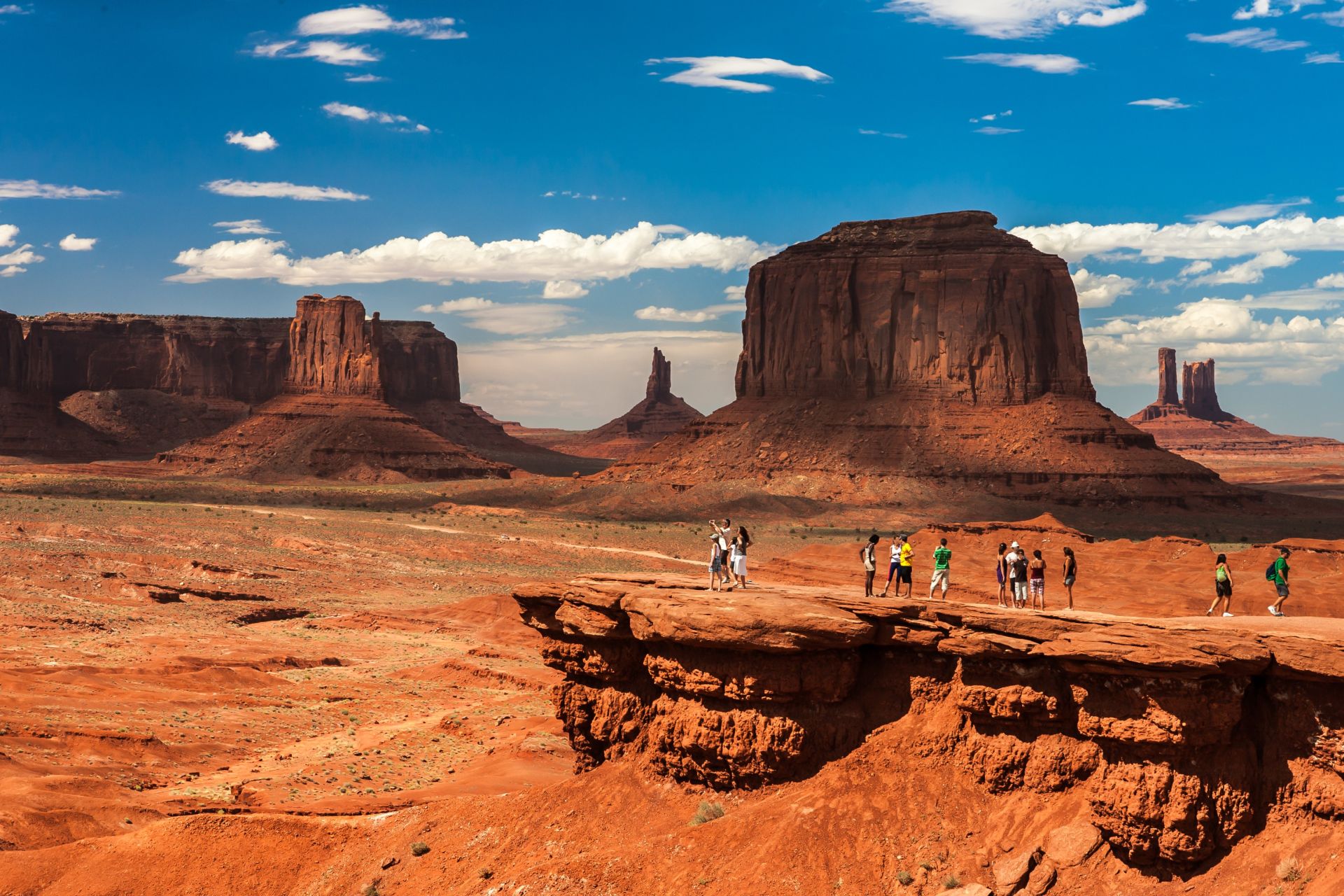 Breathtaking view of Monument Valley's iconic rock formations at sunset, showcasing vivid desert landscape.