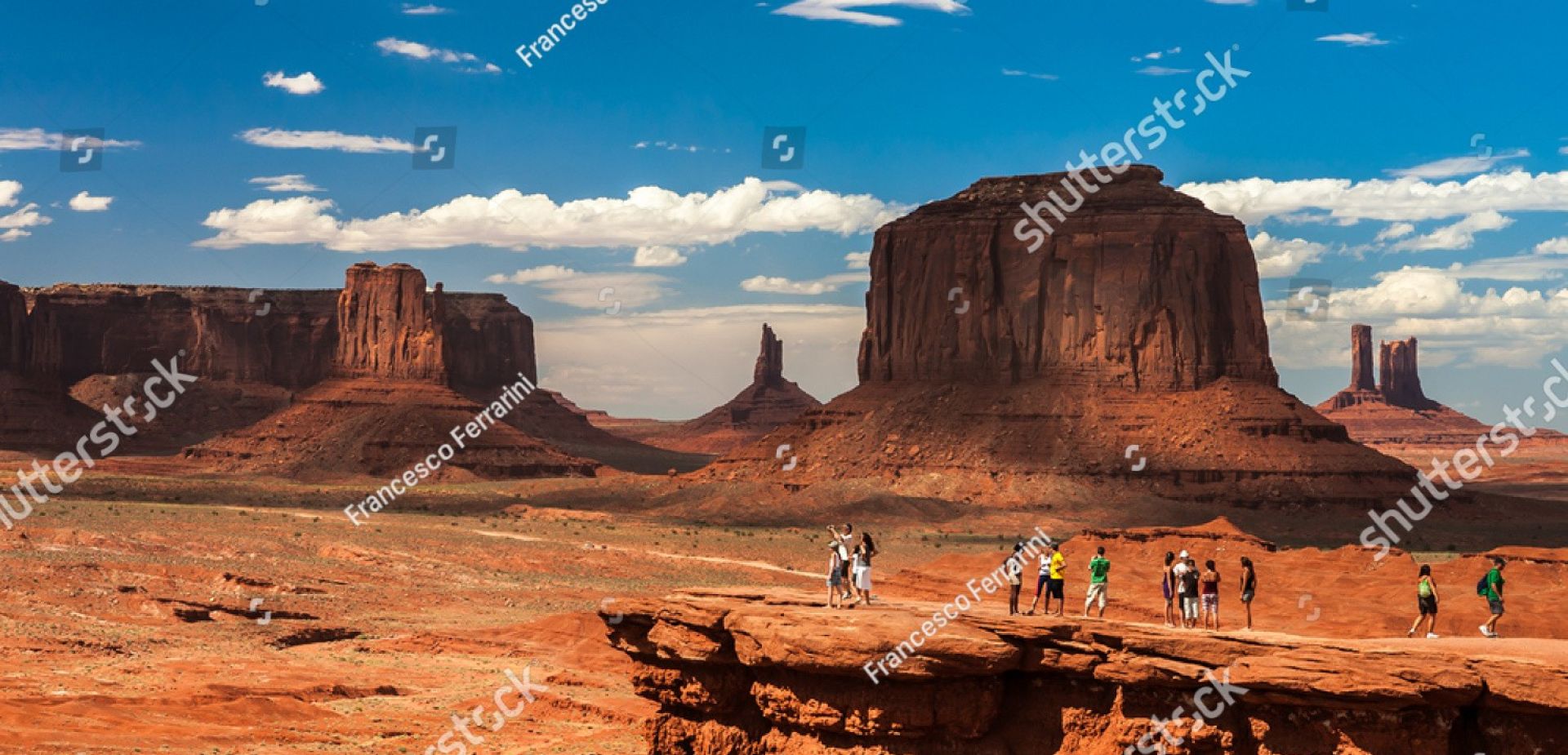 Breathtaking view of Monument Valley's iconic rock formations at sunset, showcasing vivid desert landscape.