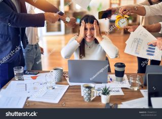 Cheerful man with coffee mug sitting in modern office with plant.